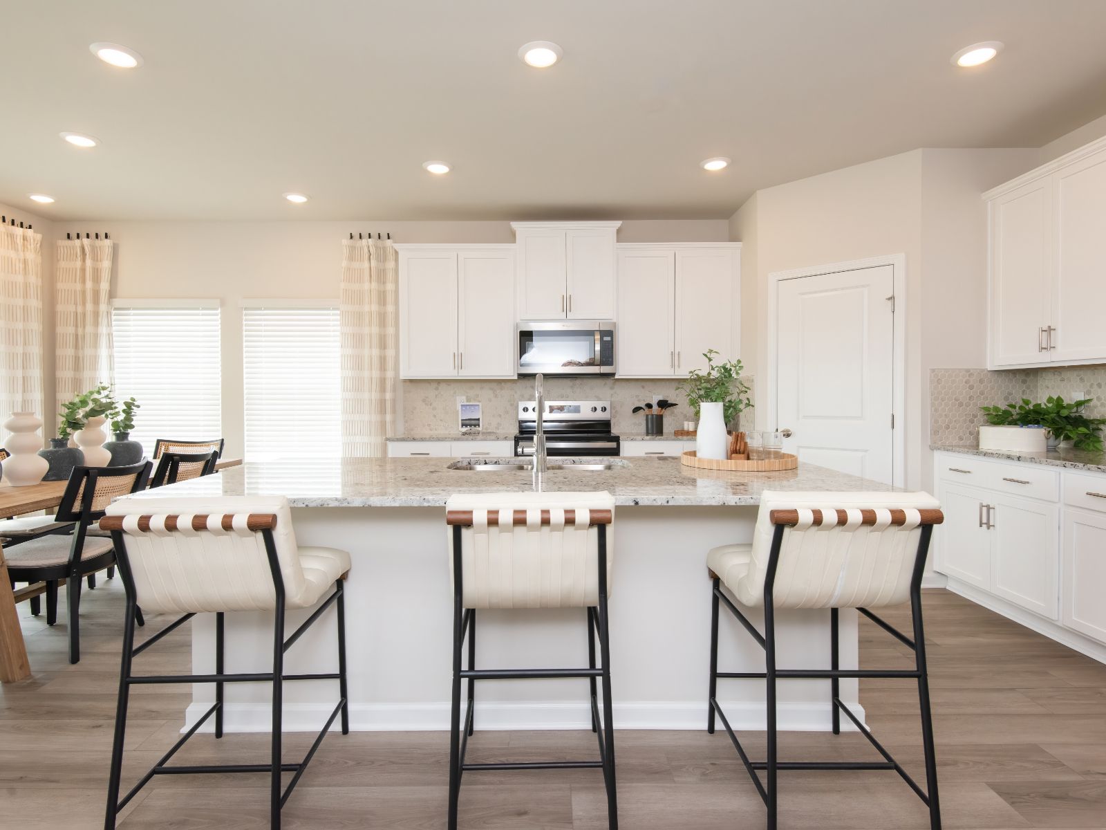 Use the oversized kitchen island as a functional bar counter for seating.