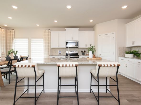 Use the oversized kitchen island as a functional bar counter for seating.