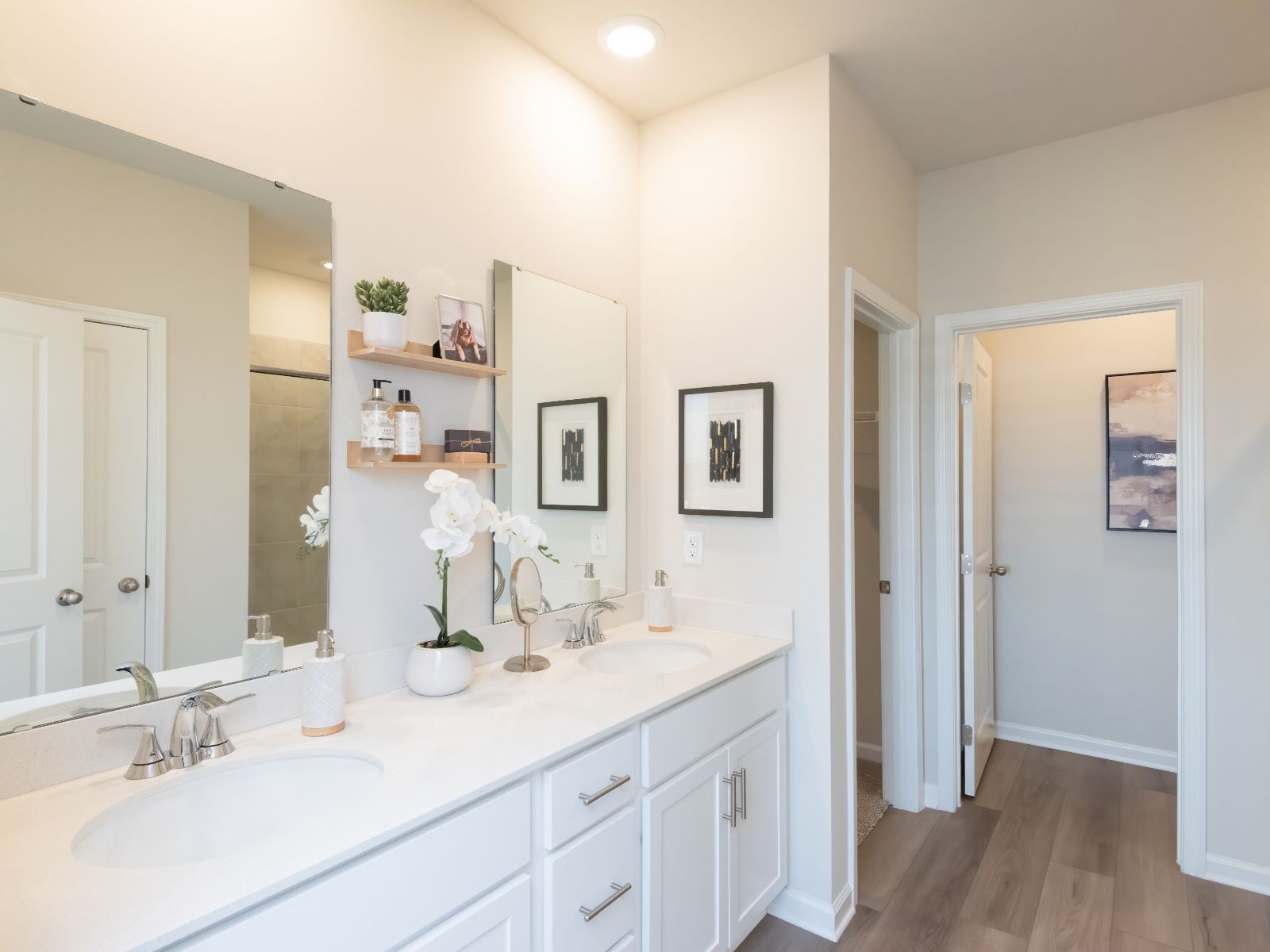 The primary bathroom boasts a dual-sink vanity and walk-in shower.