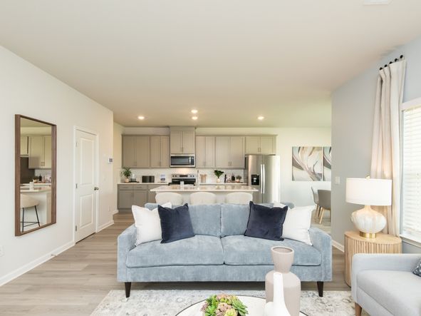 The spacious great room leads conveniently to the kitchen and dining areas.