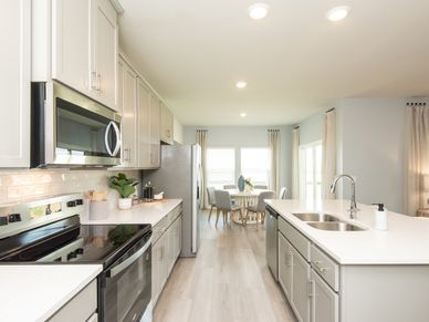 The spacious kitchen provides countless cabinets for your cooking essentials.