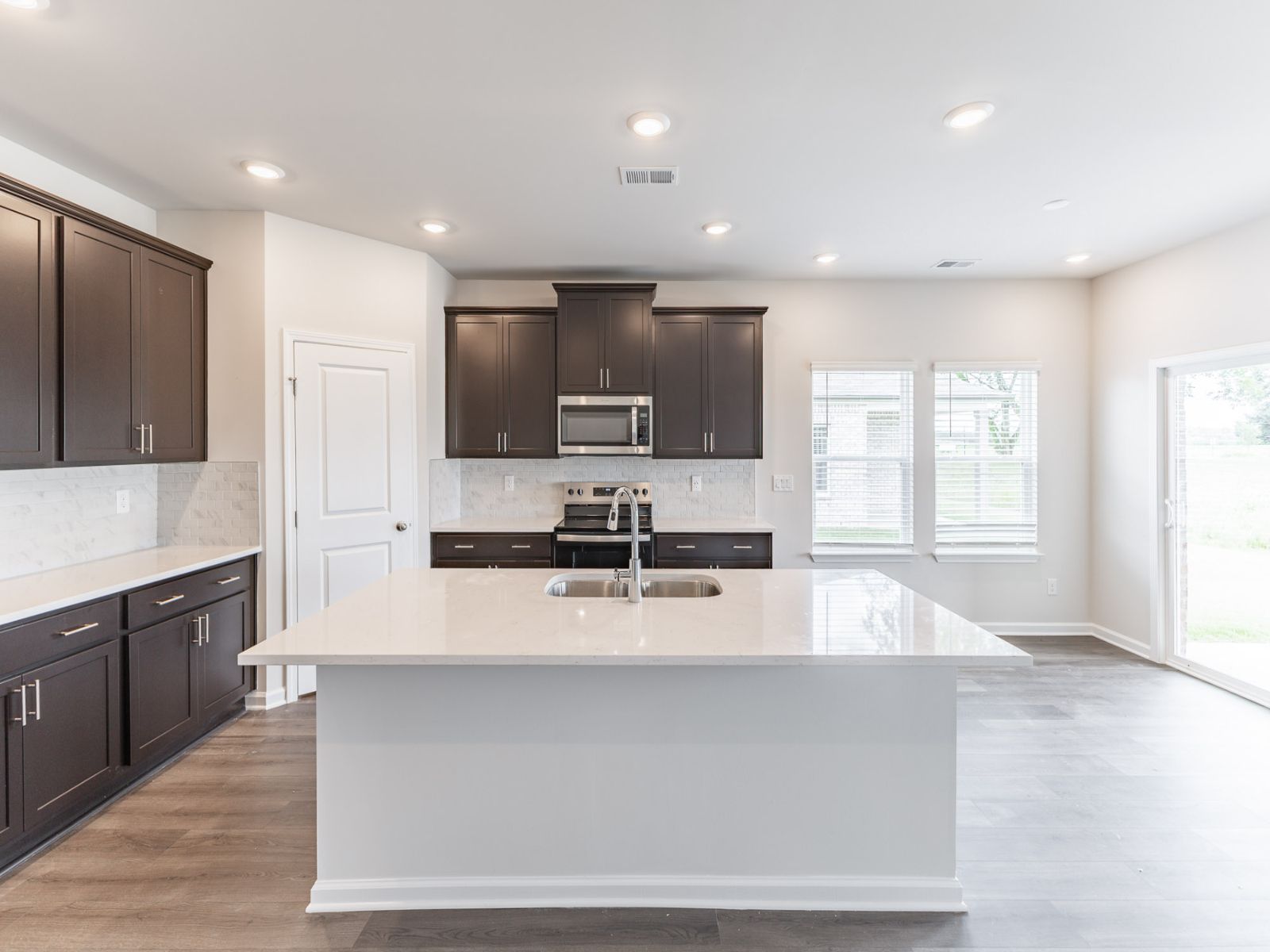 Kitchen in the Newport floorplan with the Balanced Dark interior package.