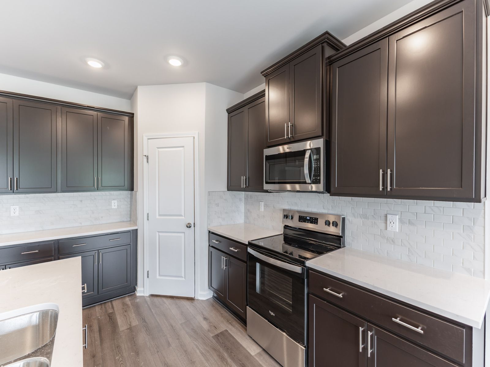 Kitchen in the Newport floorplan with the Balanced Dark interior package.