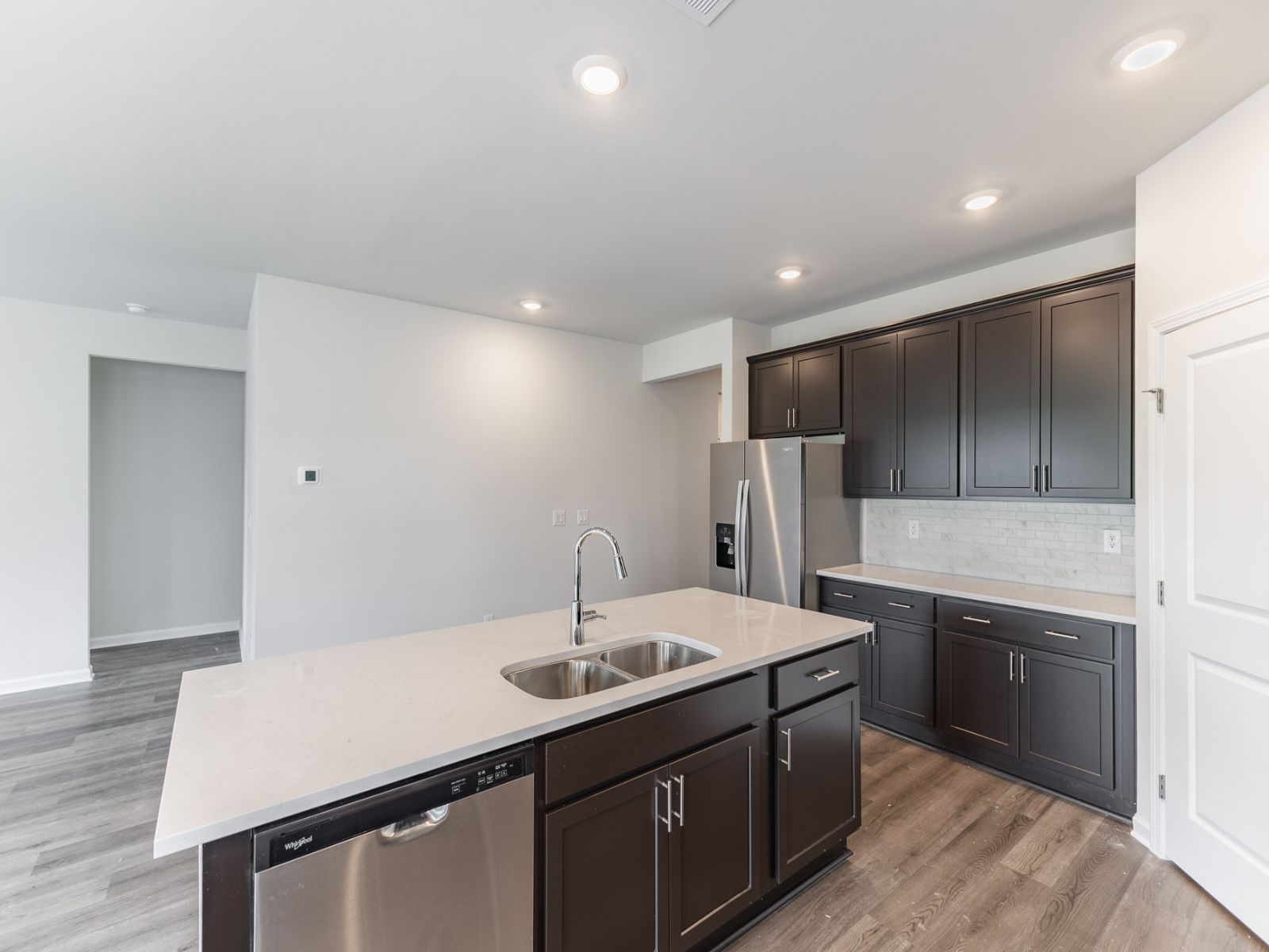 Kitchen in the Newport floorplan with the Balanced Dark interior package.