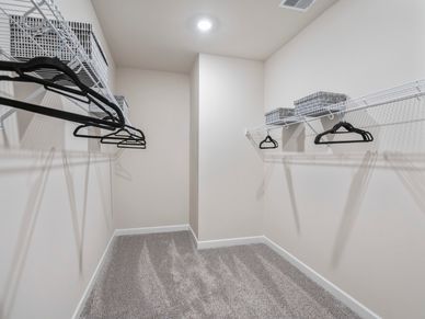 The walk-in closet off of the primary bathroom offers an abundance of space.