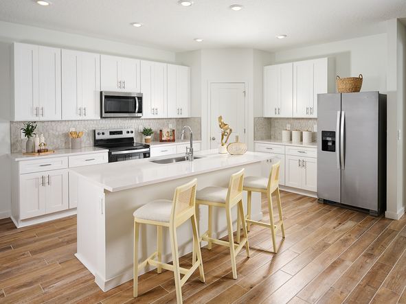 The Jasmine floorplan kitchen modeled at Azalea Creek.