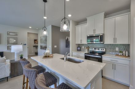 Designer-curated finishes, including marble countertops, create an elegant feel.