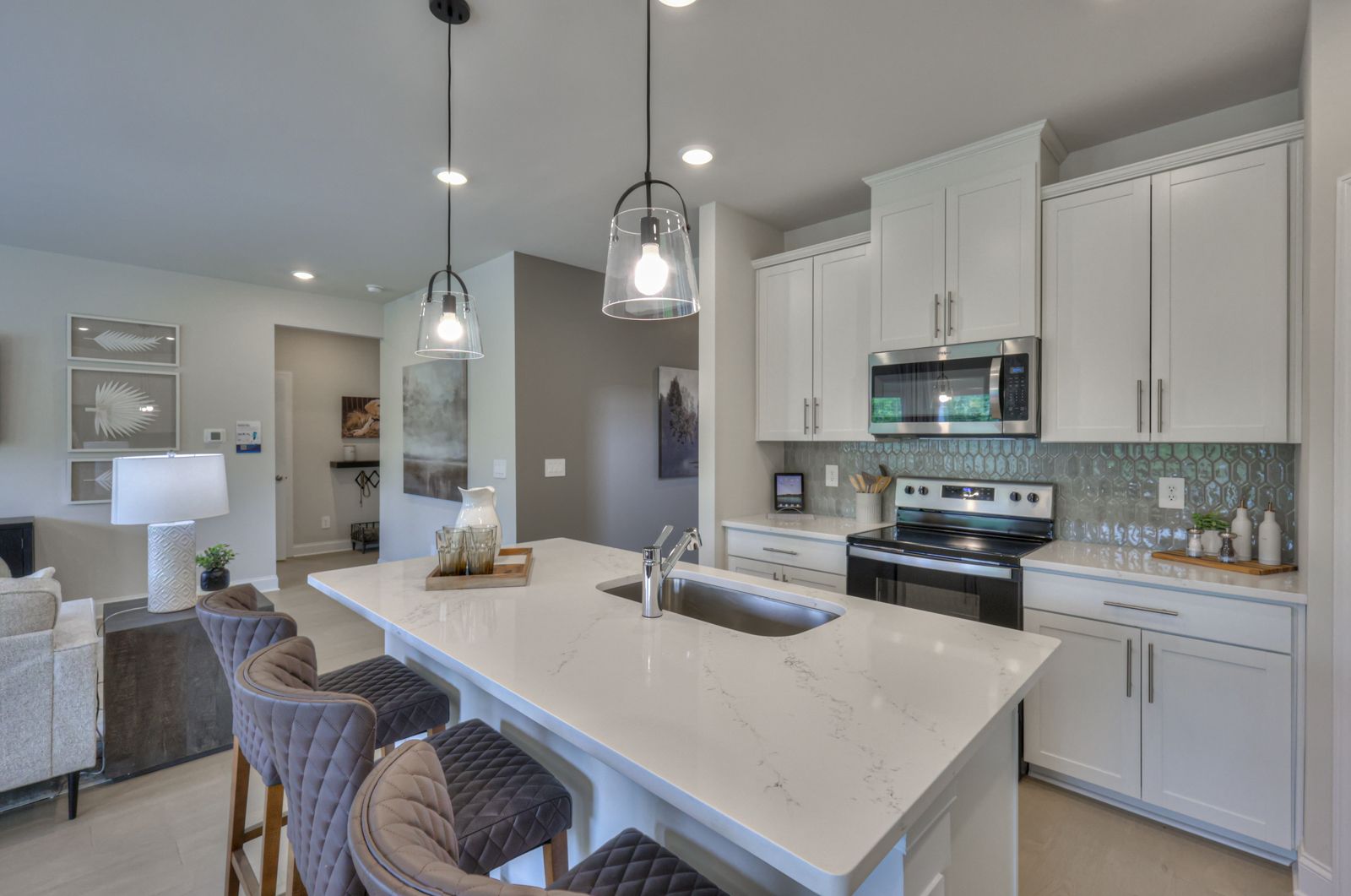 Designer-curated finishes, including marble countertops, create an elegant feel.