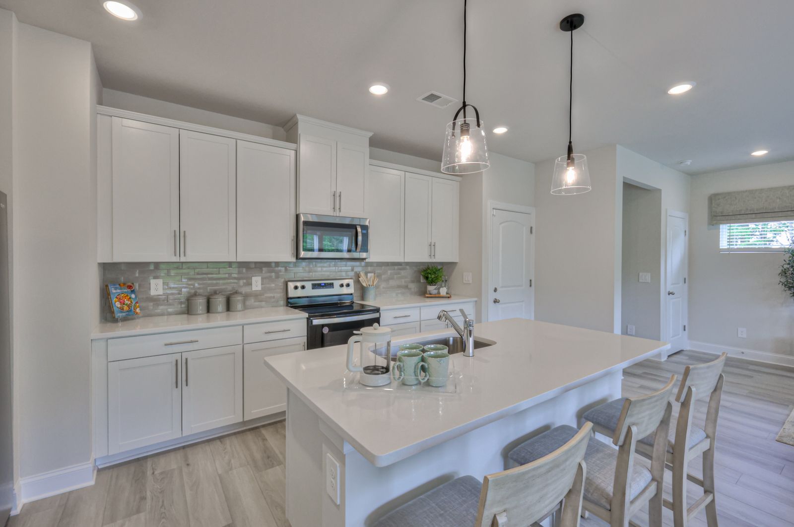 Designer-curated finishes, including marble countertops, create an elegant feel.