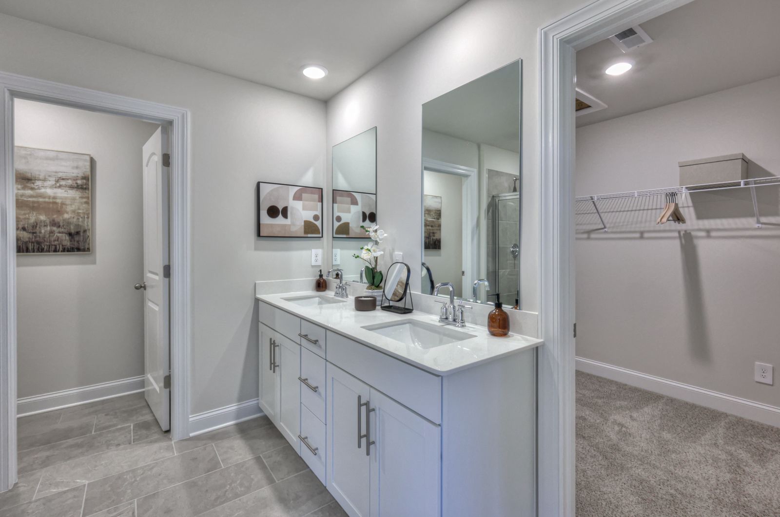 The primary bathroom offers dual vanity sinks and a walk-in closet.