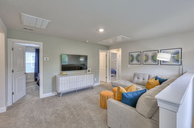 The upstairs loft separates the secondary bedrooms from the primary suite.