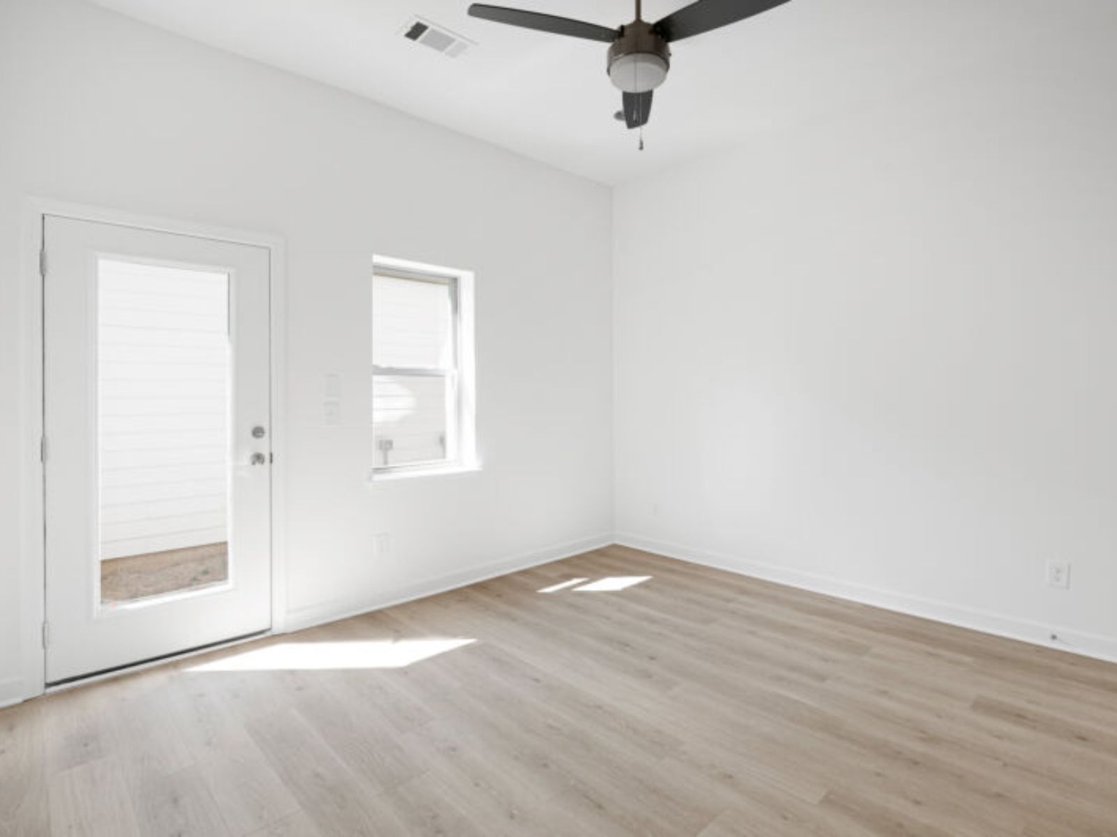 The primary suite opens up to the back patio.
