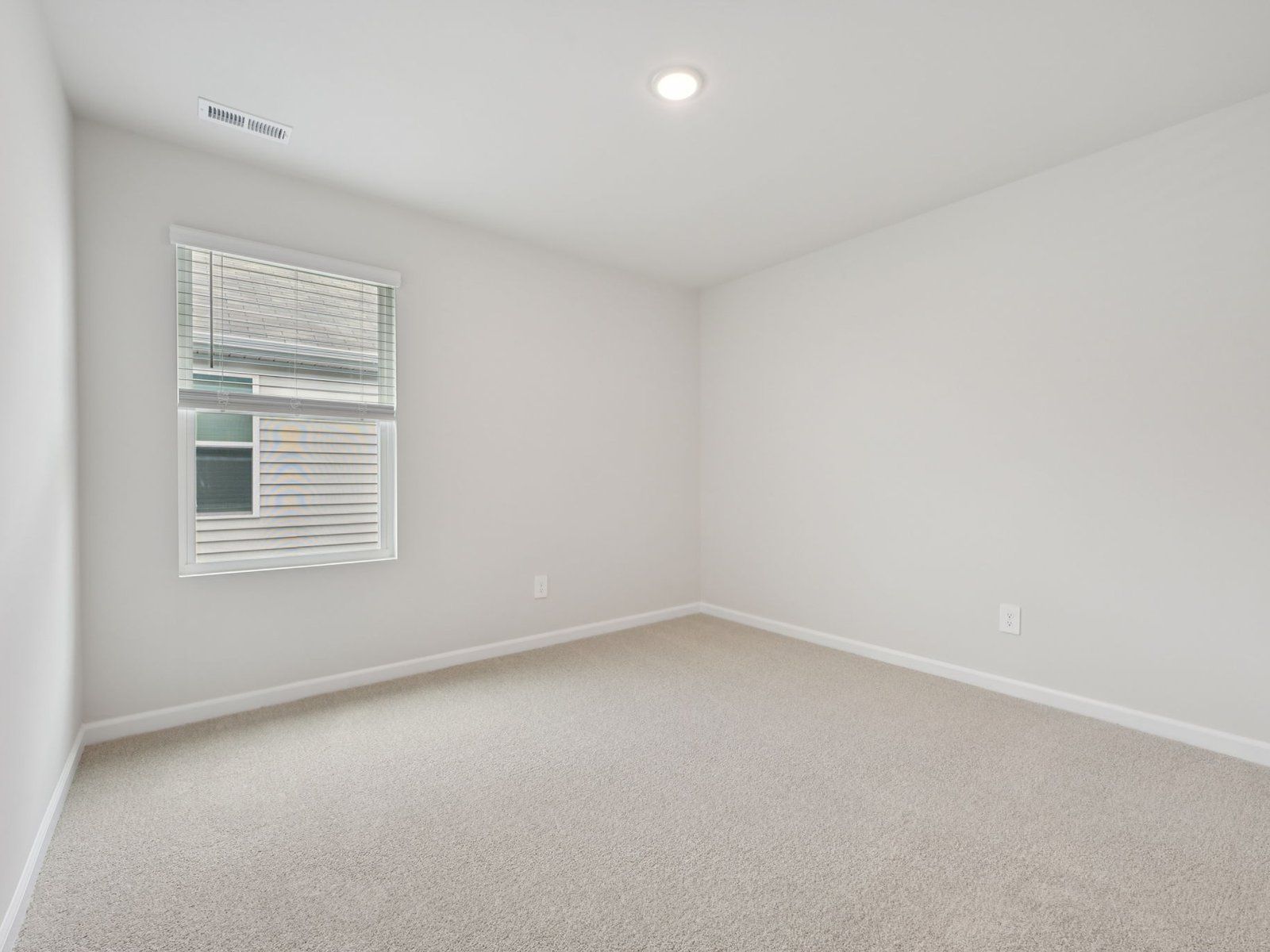 Secondary bedroom in the Brentwood floorplan at a Meritage Homes community in Garner, NC.