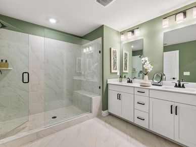 Enjoy a spa-like experience in the primary bathroom with a modern walk-in shower.