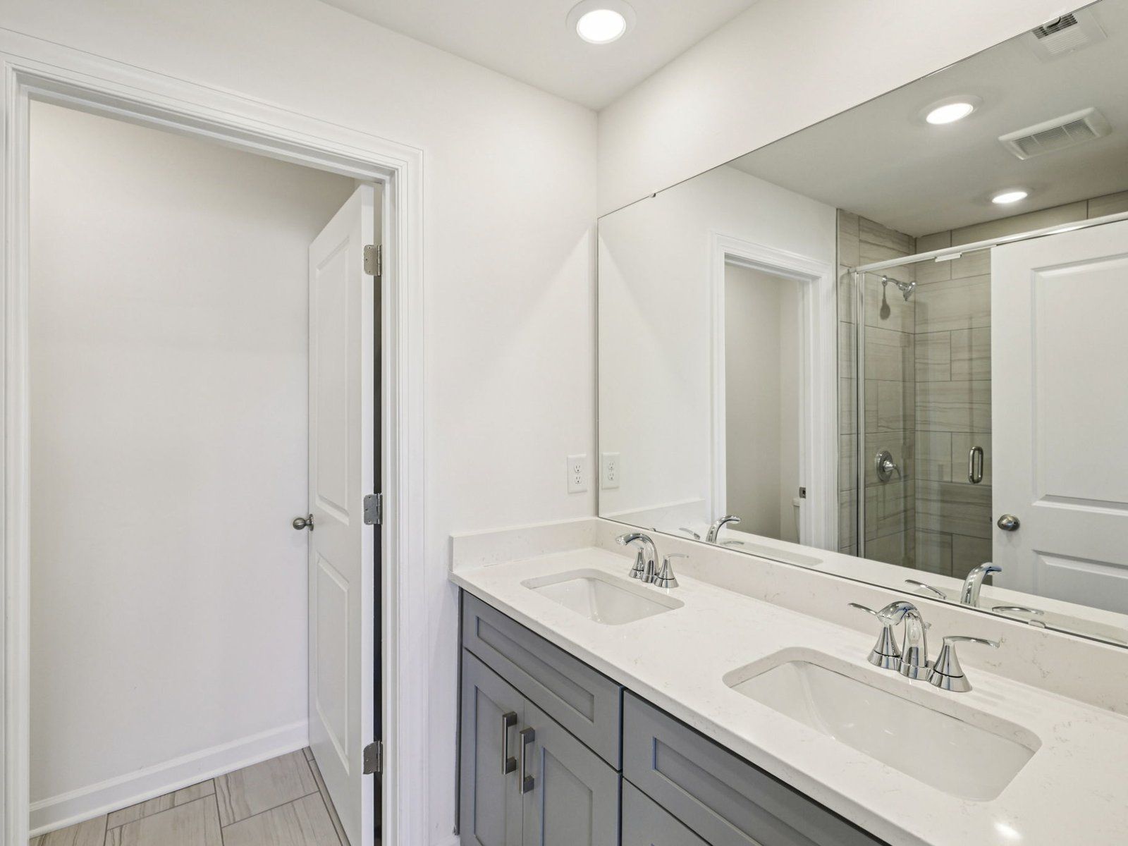 The primary bathroom boasts a spacious dual-sink vanity.