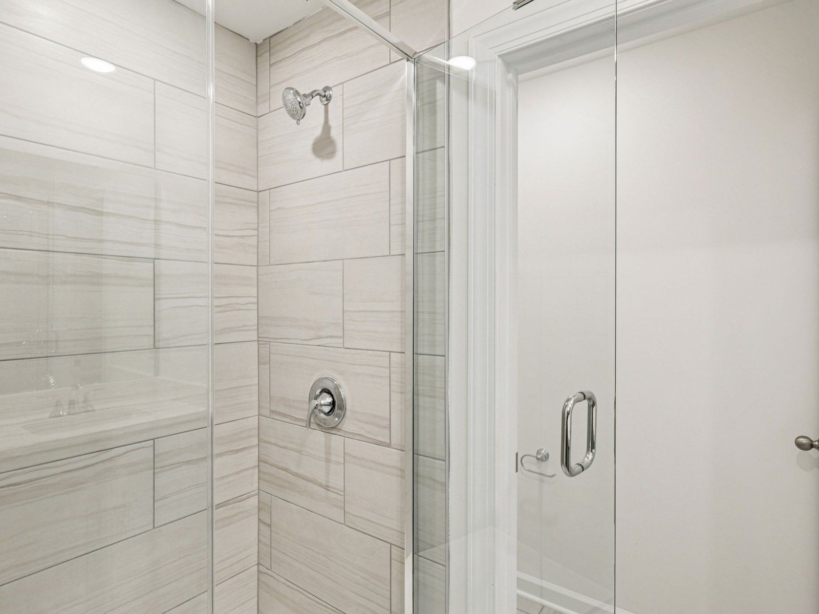 The primary bathroom includes a modern and spacious walk-in shower.