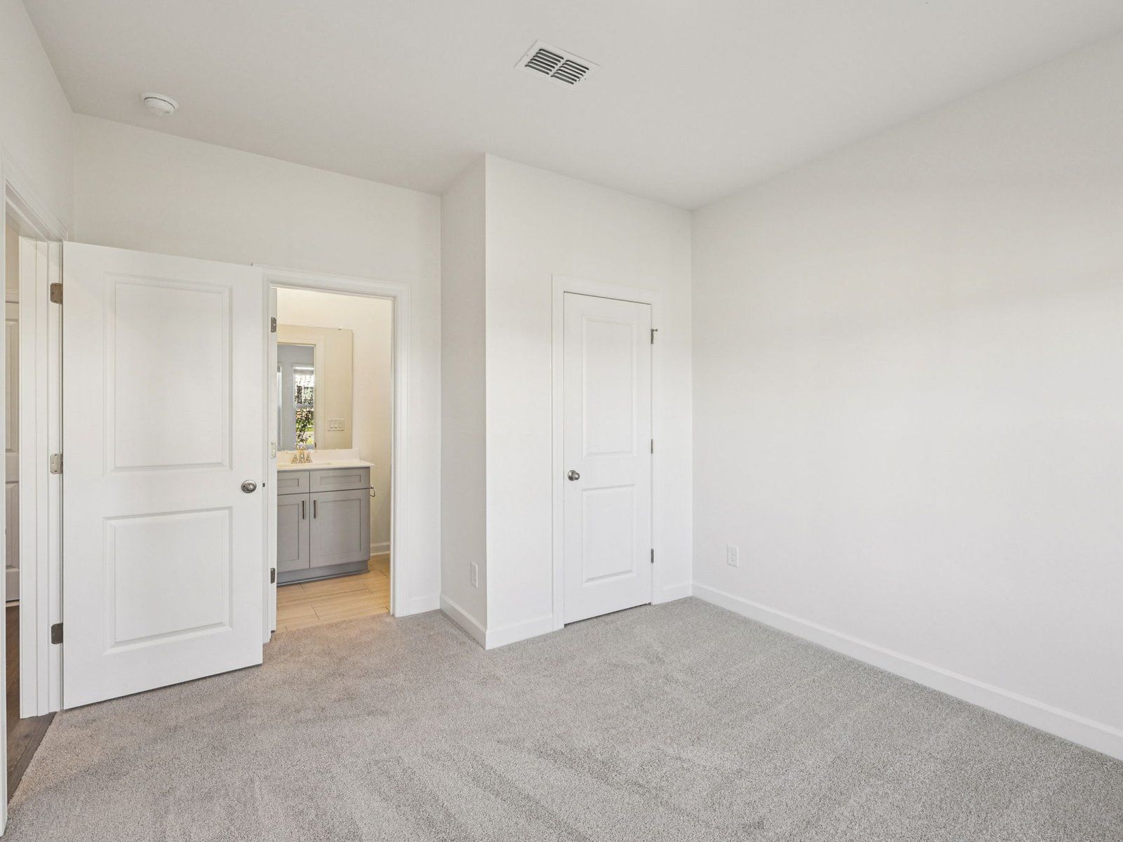 The downstairs secondary bedroom includes a private bath, perfect for guests.