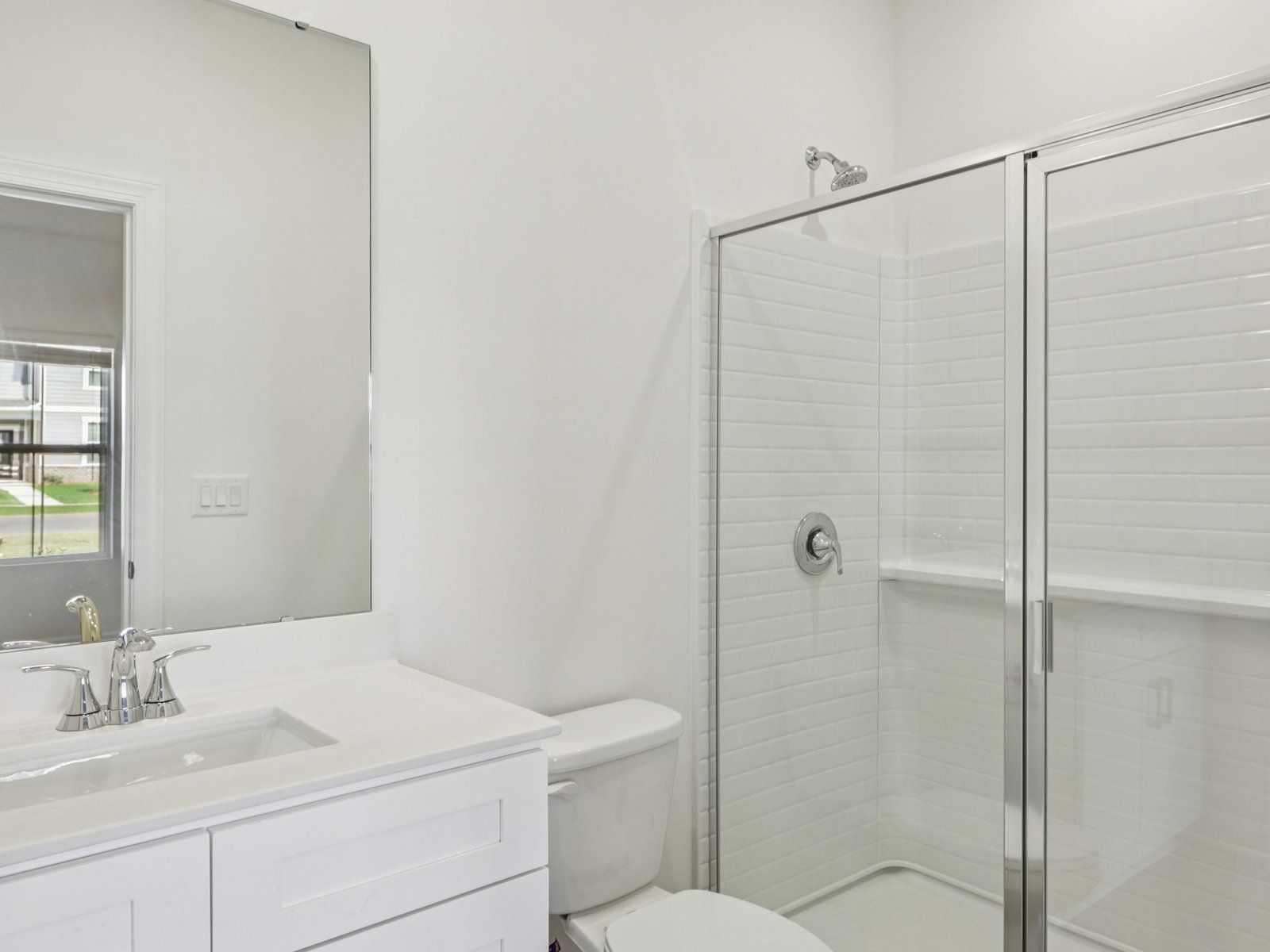 The downstairs secondary bedroom boasts a private full bath.