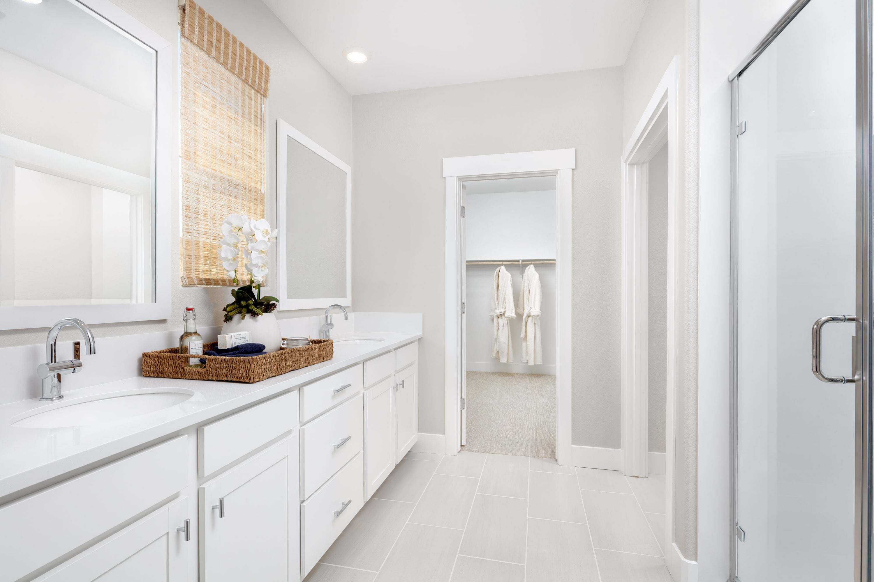 Primary bathroom to entrance of walk-in closet at Plan 3501 at Bridgeway at River Islands