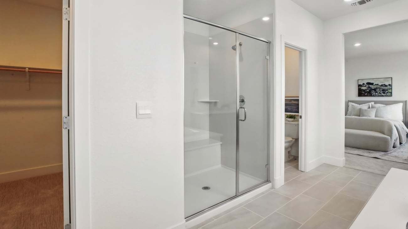 Primary Bath and Walk-in Closet at Plan 5002, The Residences at Arbor Ranch