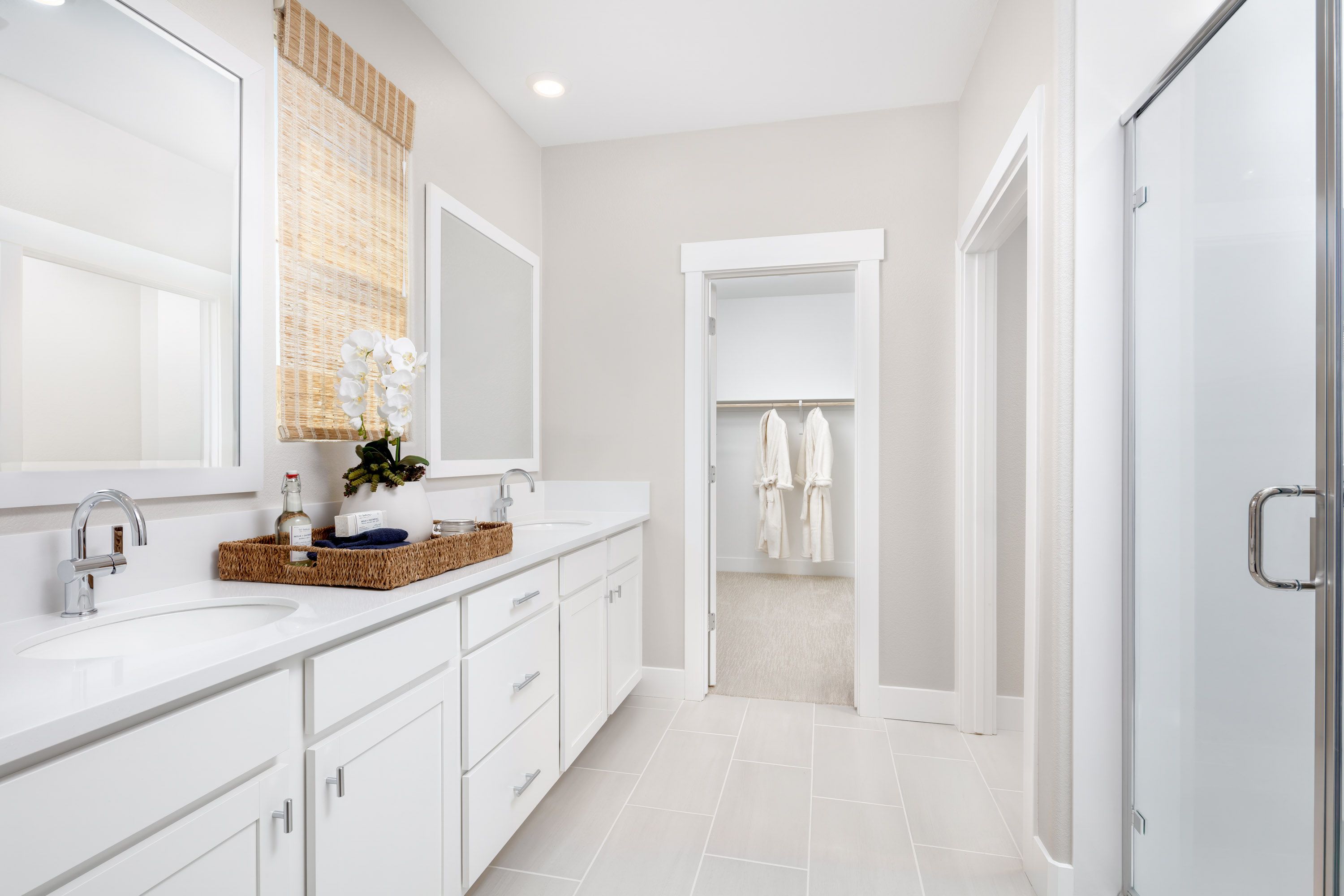 Primary bathroom to entrance of walk-in closet at Plan 3501 at Bridgeway at River Islands