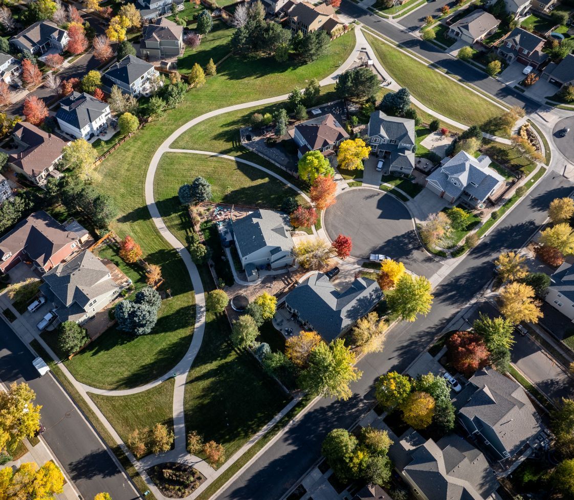 Bird’s-eye view of the community, with cozy homes, glowing lights, and a welcoming feel from above.