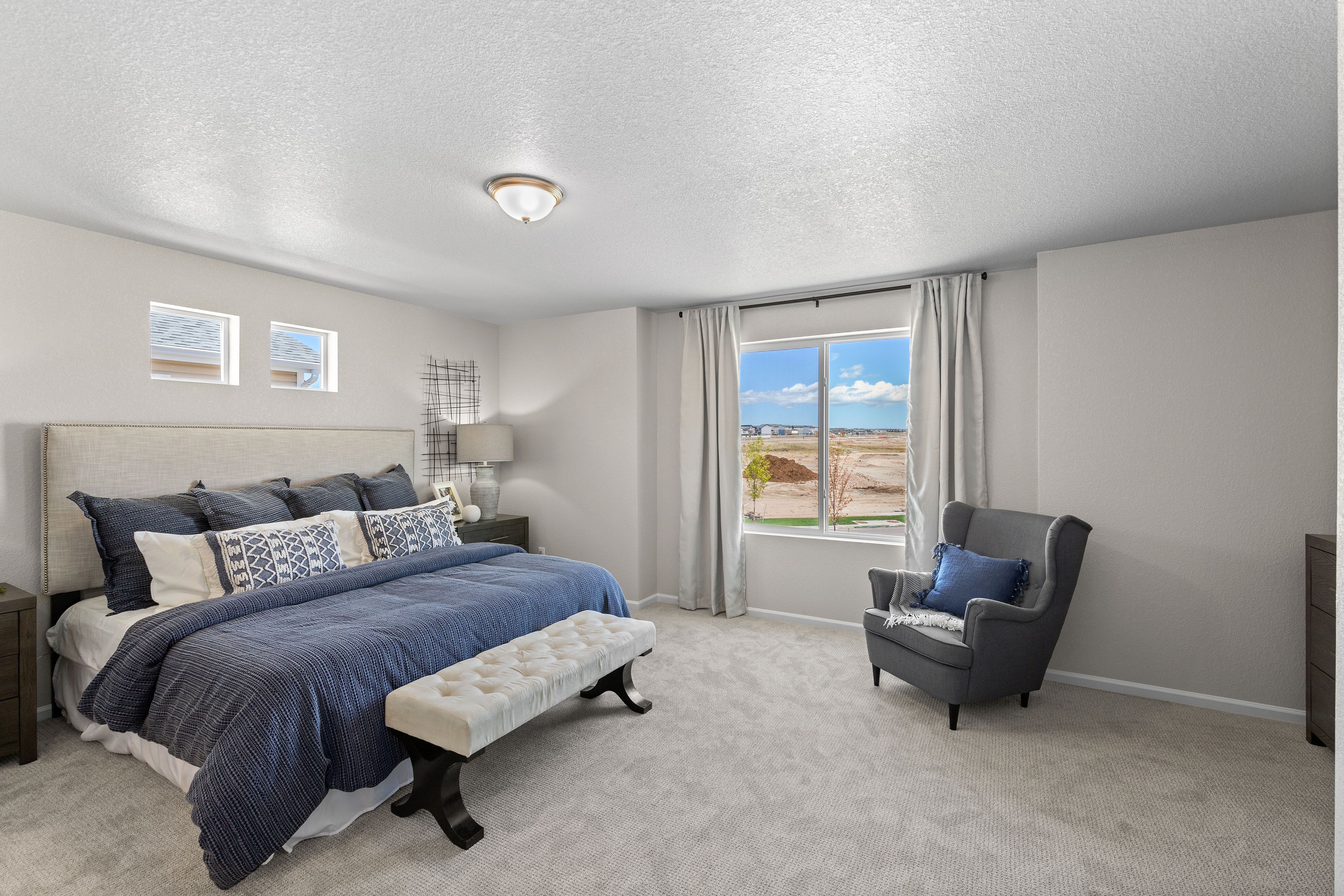 A view of the primary bedroom sitting area by the window