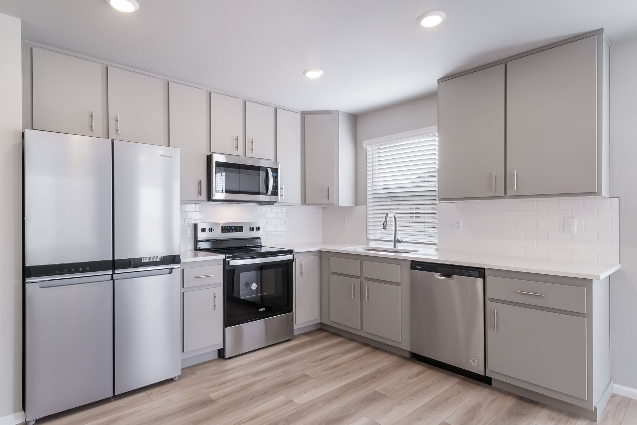Kitchen which inclues Samsung stainless steel appliances including a refrigerator.