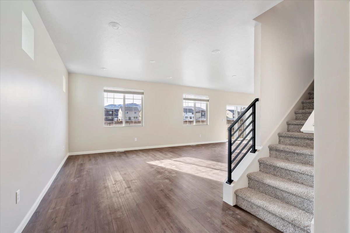 A view of the great room and stairwell from the entry