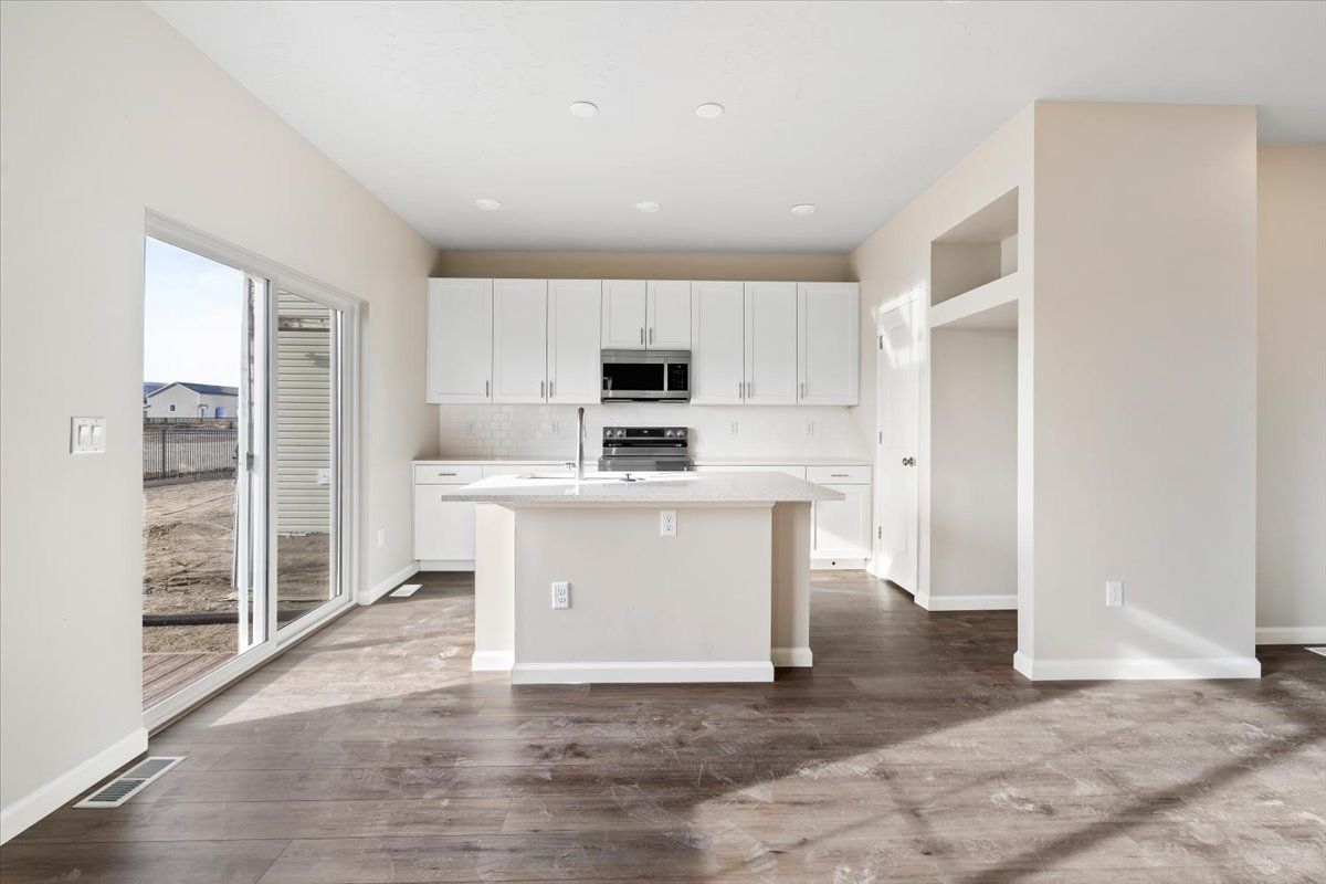 A view of the kitchen, island and patio entry
