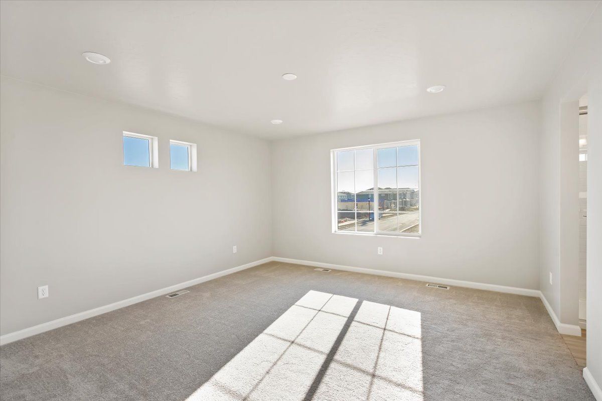 A view of the primary bedroom and windows