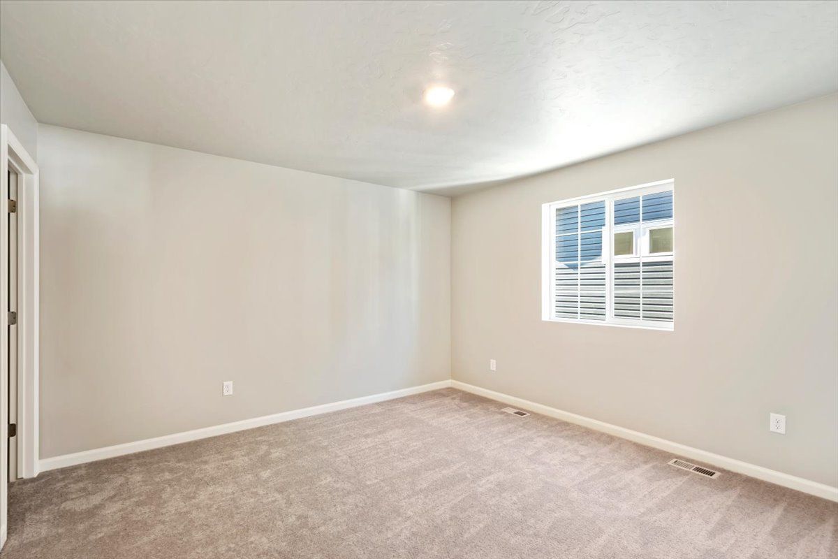 A view of the third bedroom and windows