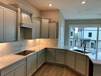 Quartz countertops in kitchen that extend as the backsplash for a seamless look