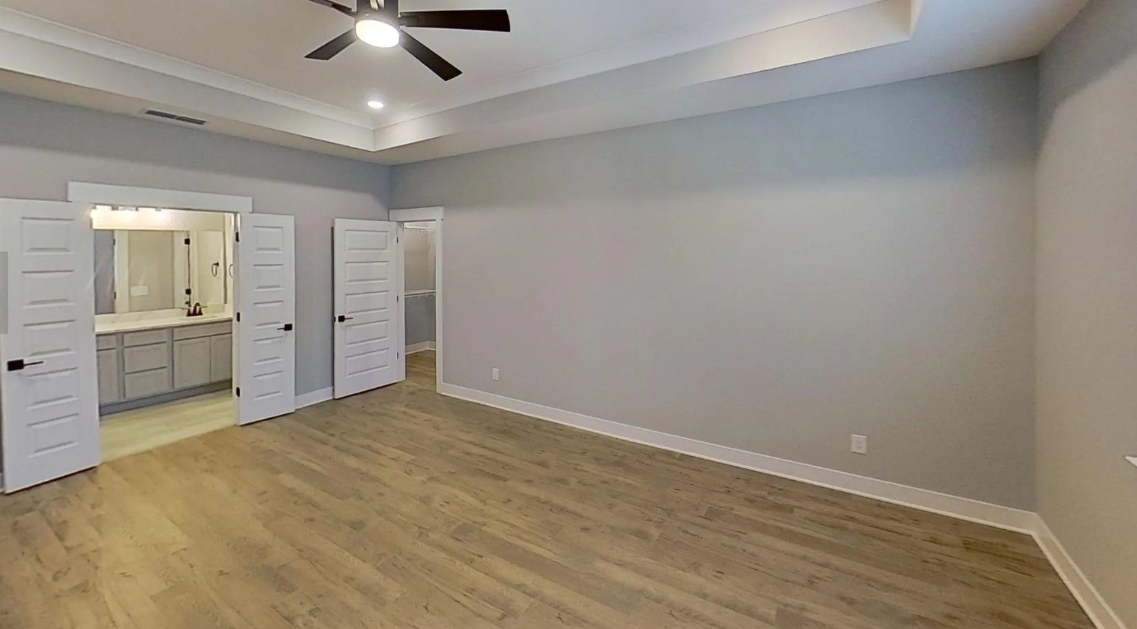 Relax in this large owners suite which features tray ceilings and French doors into the bathroom