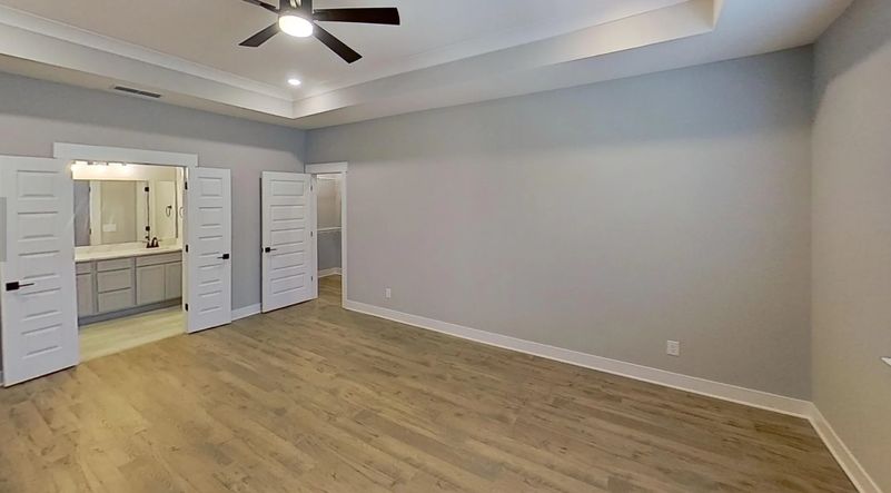 Relax in this large owners suite which features tray ceilings and French doors into the bathroom