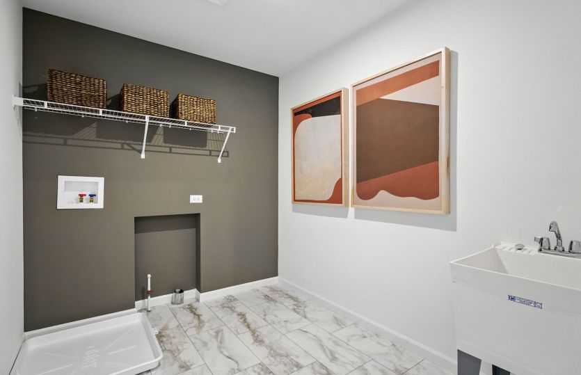 Laundry room with utility sink and shelving