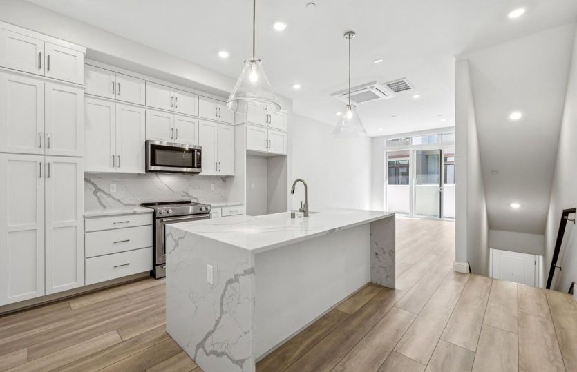 Kitchen with waterfall edge countertop at island