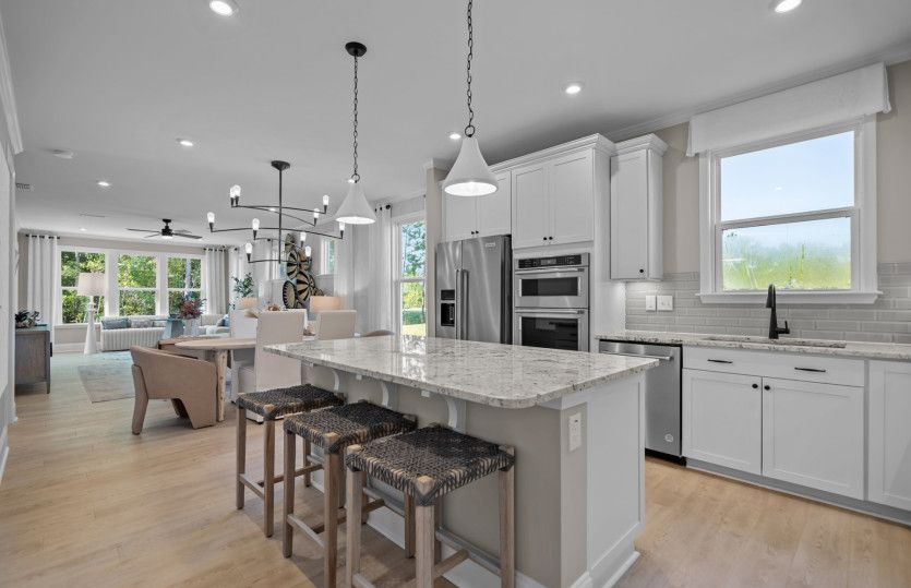 Large Kitchen Island with Seating. Model Home Representation.