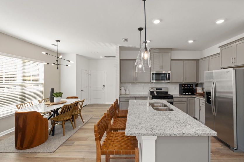 Kitchen with Eat-In Island is Open to Dining Area - Model Representation