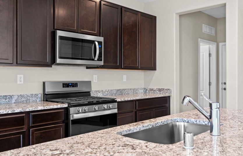 Kitchen layout featuring granite and stainless steel appliances.
