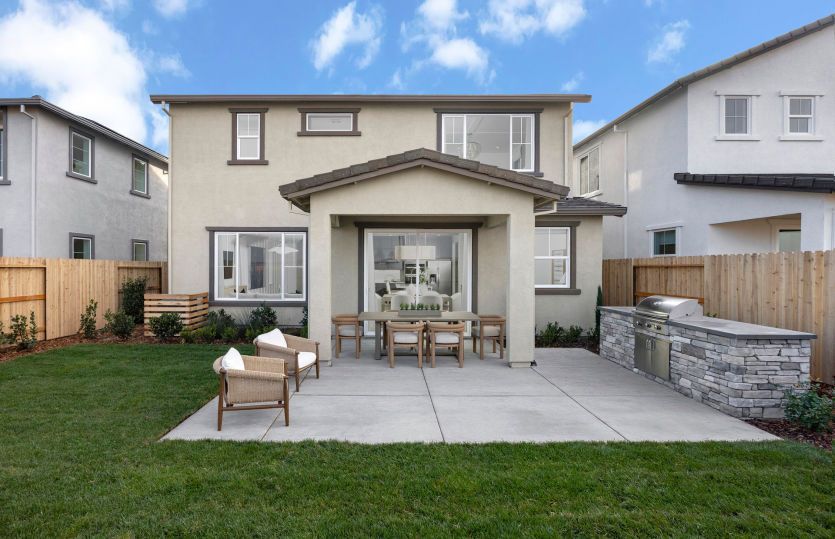 Backyard with covered patio and built-in outdoor kitchen