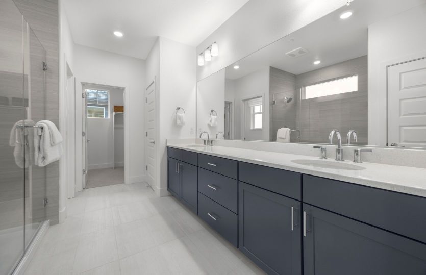 Primary bath with dual vanity and a glass walk-in shower