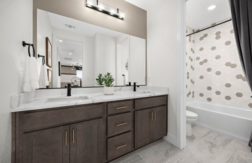 Secondary bathroom with dual vanity and tub-shower