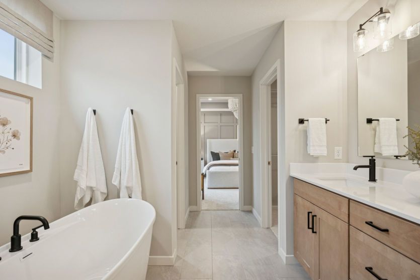 Indulge in spa-like luxury with a soaking tub, walk-in shower, and dual vanities.