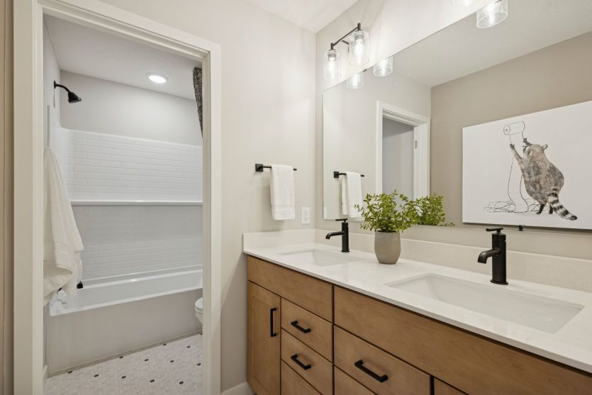 A modern shared bathroom with dual sinks and plenty of space for busy mornings.