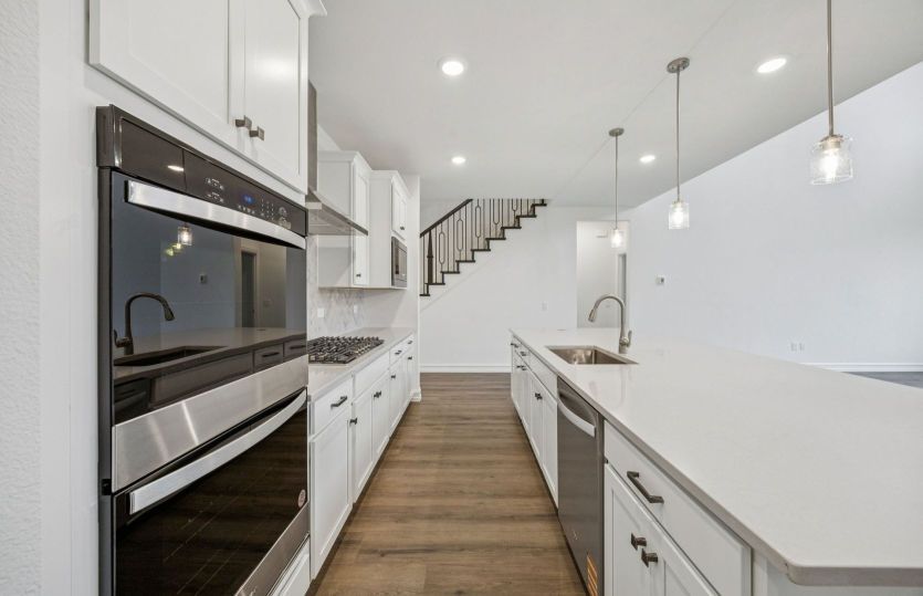 Recessed and pendant lighting in kitchen *photos depict options and features that may not be available