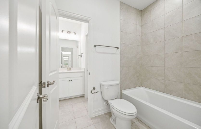 Secondary bathroom with tile-surround bath *photos depict options and features that may not be available