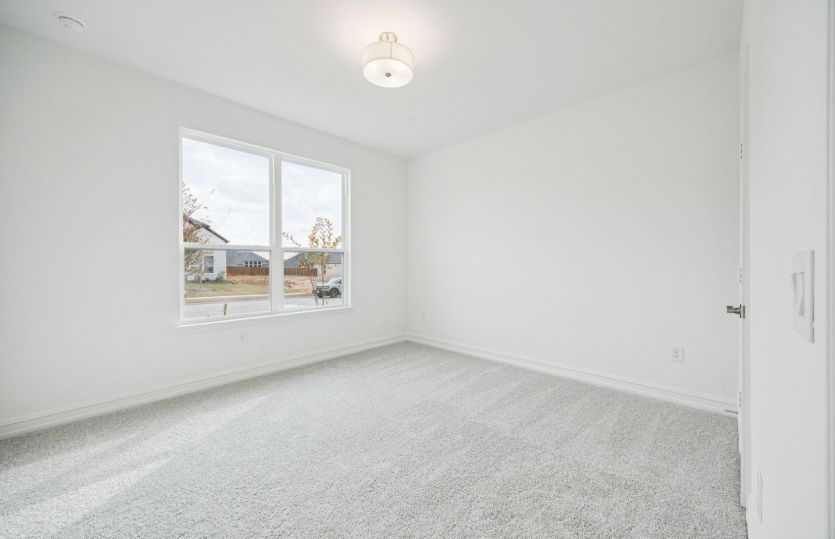 Comfortable guest bedroom with convenient access to nearby bathroom.
