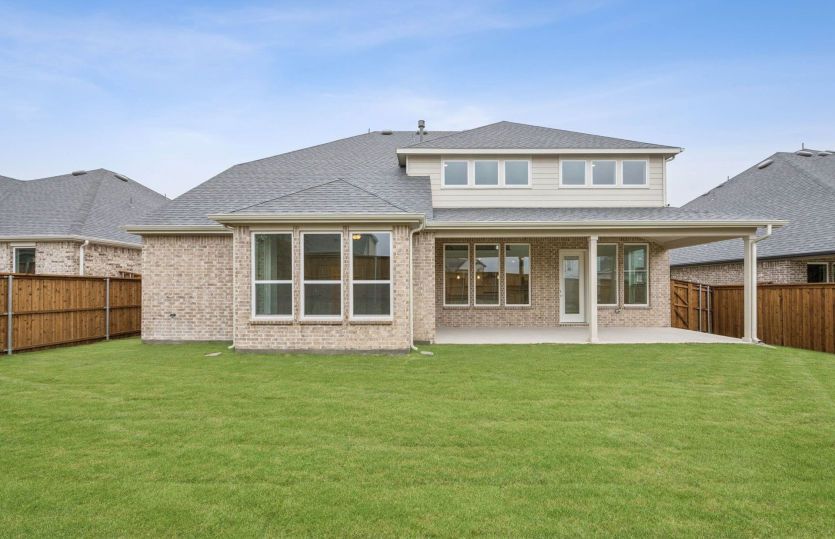 Fenced-in backyard with covered patio *photos depict features and options that may not be available