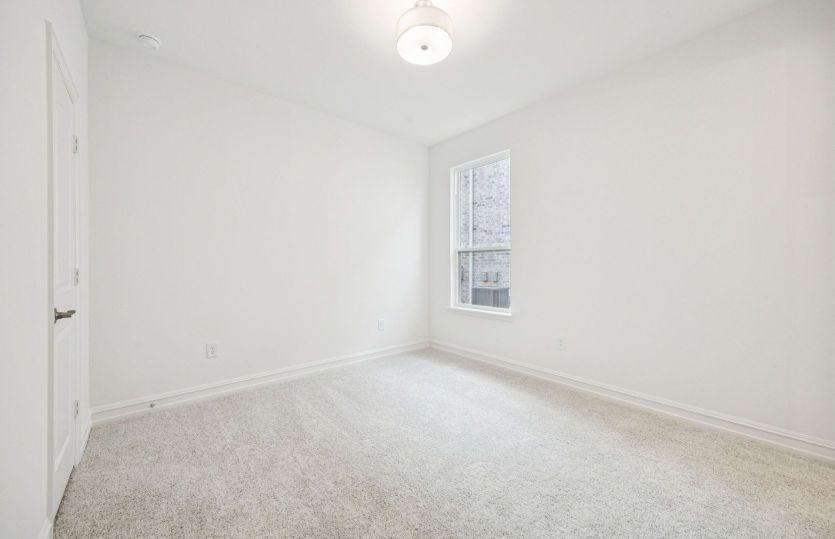Versatile secondary bedroom with natural light and ample closet space.